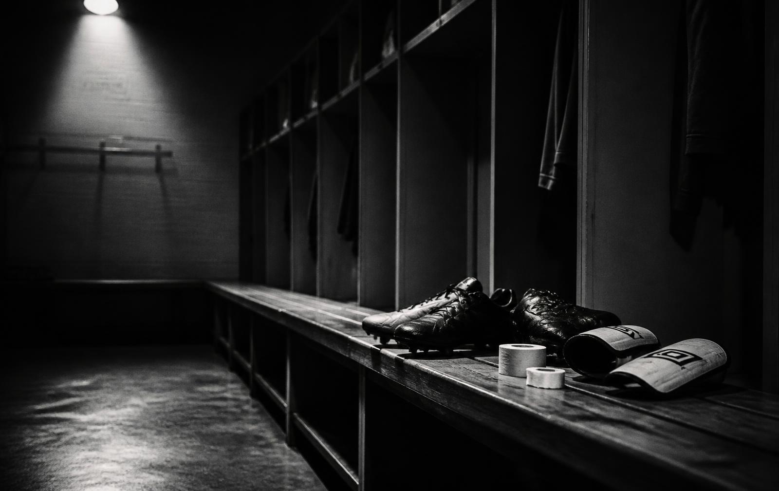 Boots and tape in a dark locker room